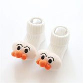 White ribbed baby socks with plush cartoon faces and orange pom-pom noses, soft material