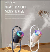 Black and white modern tabletop humidifiers with colorful LED tops emitting visible mist.