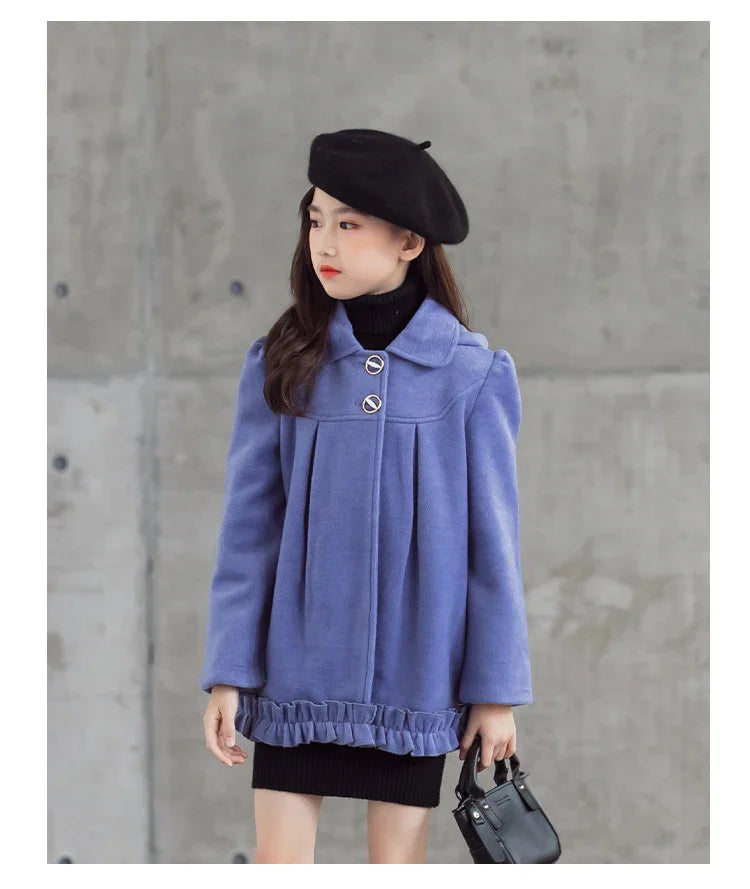 Girl in loose-fit lavender wool coat with ruffle hem, black beret, and black turtleneck dress