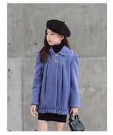Girl in loose-fit lavender wool coat with ruffle hem, black beret, and black turtleneck dress