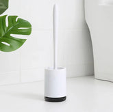 Minimalist white toilet brush with sleek handle in modern bathroom setting