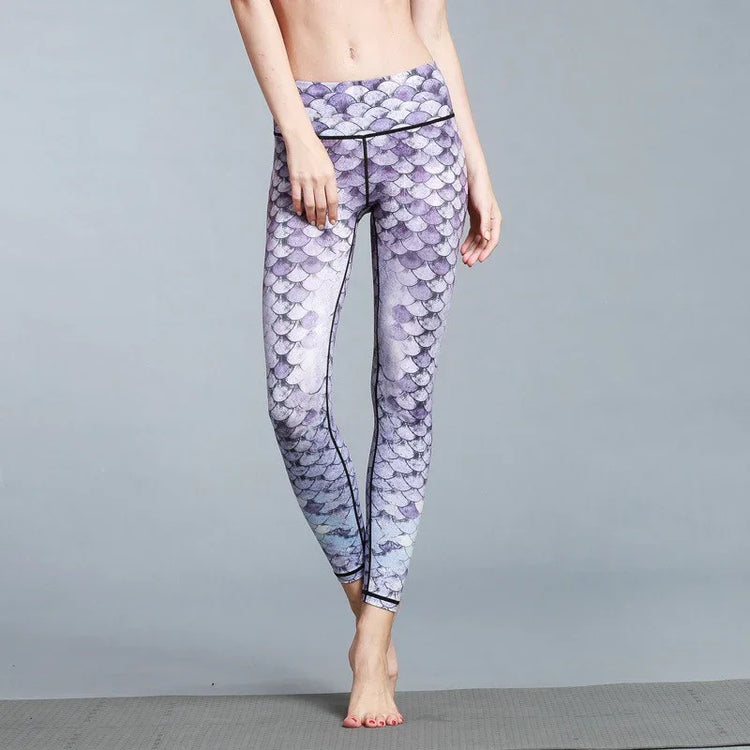 Woman wearing high-waisted, purple scale-print leggings, slim fit, stretchy fabric