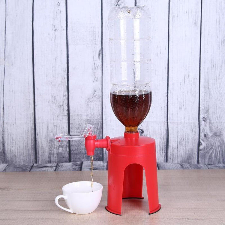 Red plastic bottle dispenser stand pouring dark liquid into white cup on wooden table