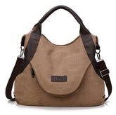 Brown canvas shoulder bag with dark brown faux leather accents and adjustable strap