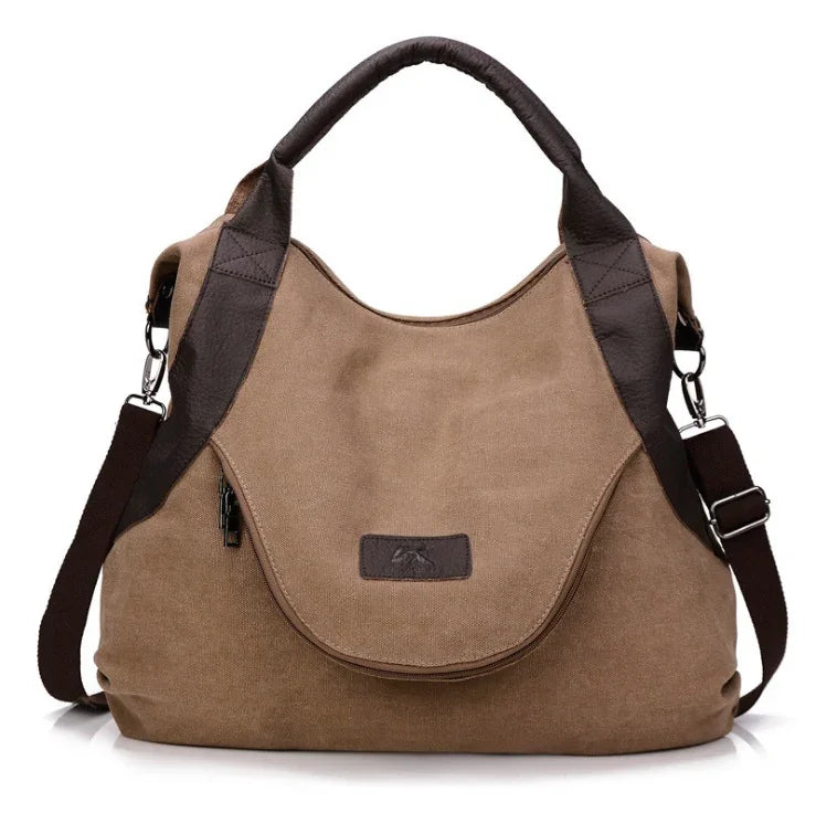 Brown canvas shoulder bag with dark brown faux leather accents and adjustable strap