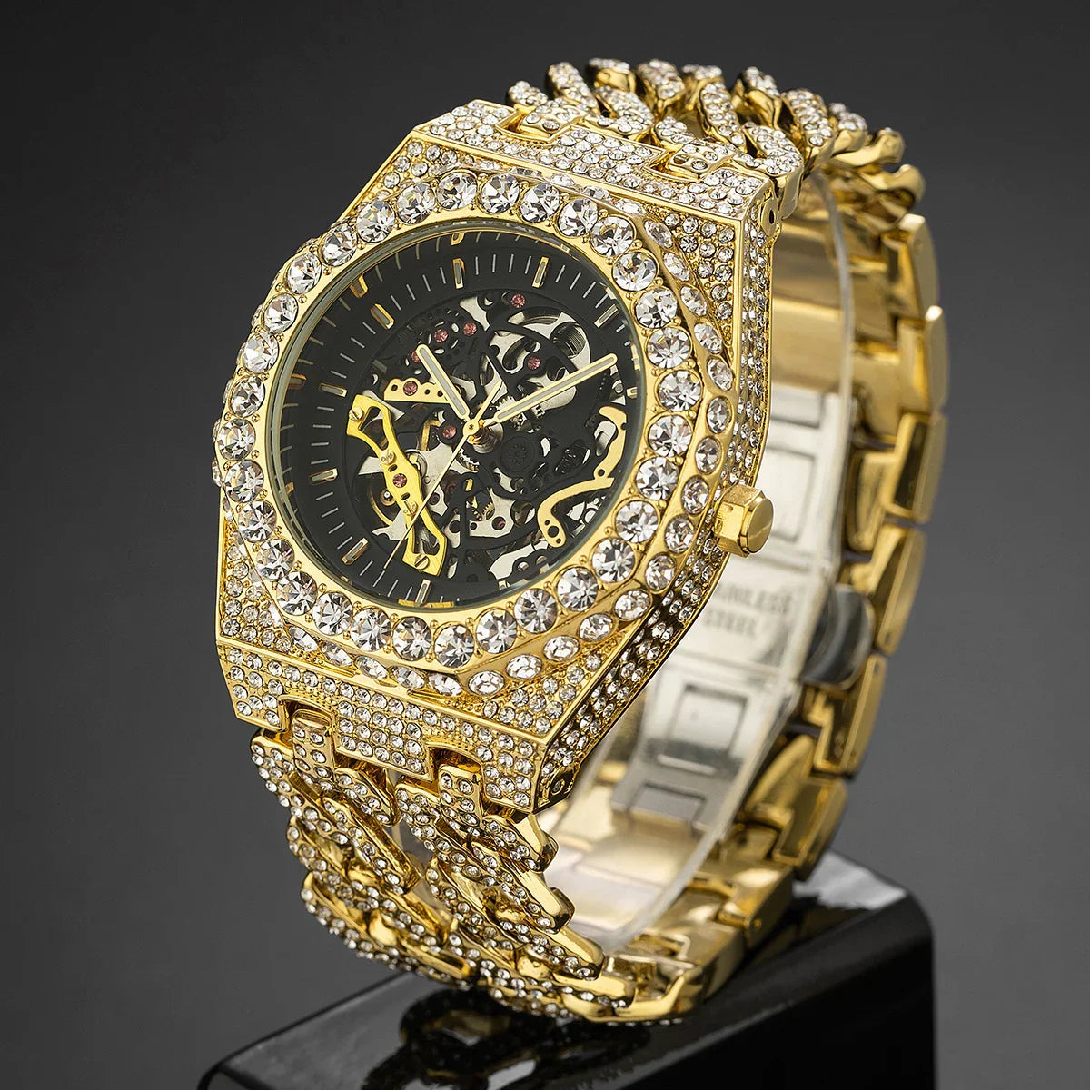 Luxury gold skeleton watch with rhinestone-studded bezel and band, bold streetwear style