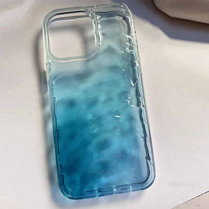 Blue ombre wavy textured phone case with glossy transparent finish on a white surface