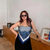 Woman wearing blue and white paisley scarf top with thin straps, relaxed streetwear fit