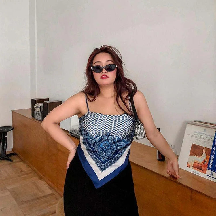 Woman wearing blue and white paisley scarf top with thin straps, relaxed streetwear fit