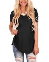 Woman in black short sleeve V-neck top with relaxed fit and ripped denim jeans