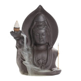Dark ceramic statue incense burner with flowing smoke and detailed robe design