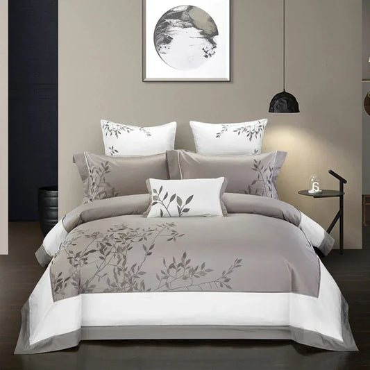 Modern bedding set in gray and white with leaf print, soft cotton material, relaxed fit.