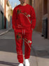 Man wearing red Christmas-themed streetwear set with palm tree and Santa print, relaxed fit.