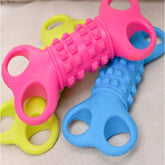 Colorful textured silicone chew toys with grip handles, in pink, blue, and yellow.