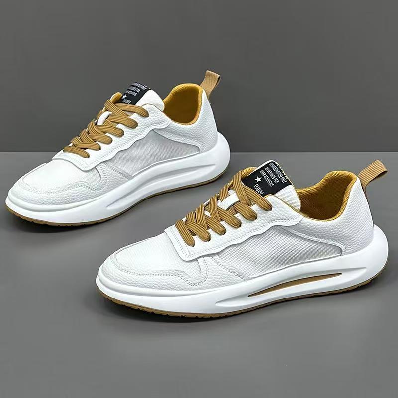 White low-top sneakers with tan laces and accents, mesh and leather mix, modern streetwear style