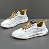 White low-top sneakers with tan laces and accents, mesh and leather mix, modern streetwear style