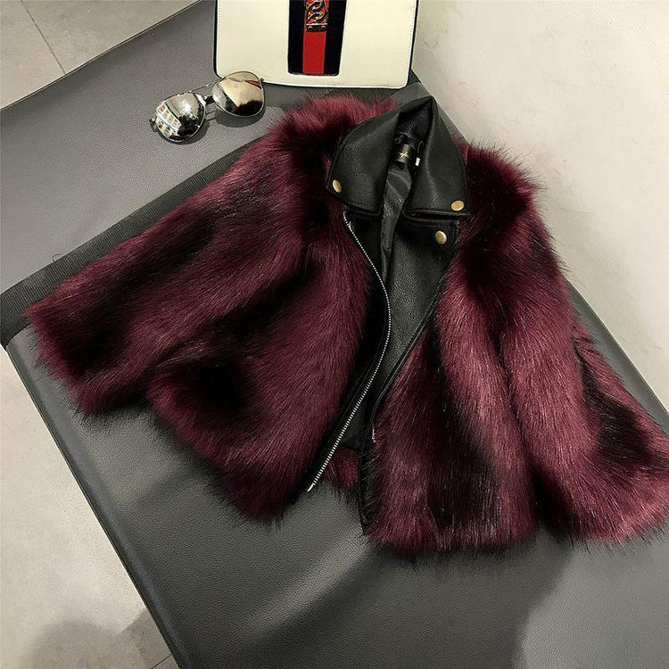Burgundy faux fur and black leather jacket with cropped fit on a bench