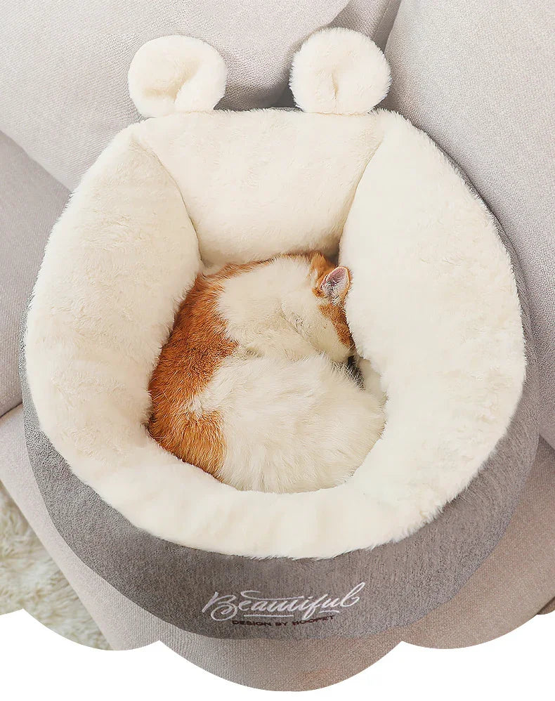 Soft plush grey and cream pet bed with a round shape, faux fur lining, and cozy fit.