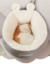 Soft plush grey and cream pet bed with a round shape, faux fur lining, and cozy fit.