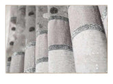 Close-up of light beige curtains with silver glitter accents and textured fabric.