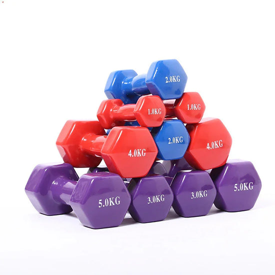 Stack of colorful hexagonal dumbbells in red, blue, and purple, glossy finish, various weights