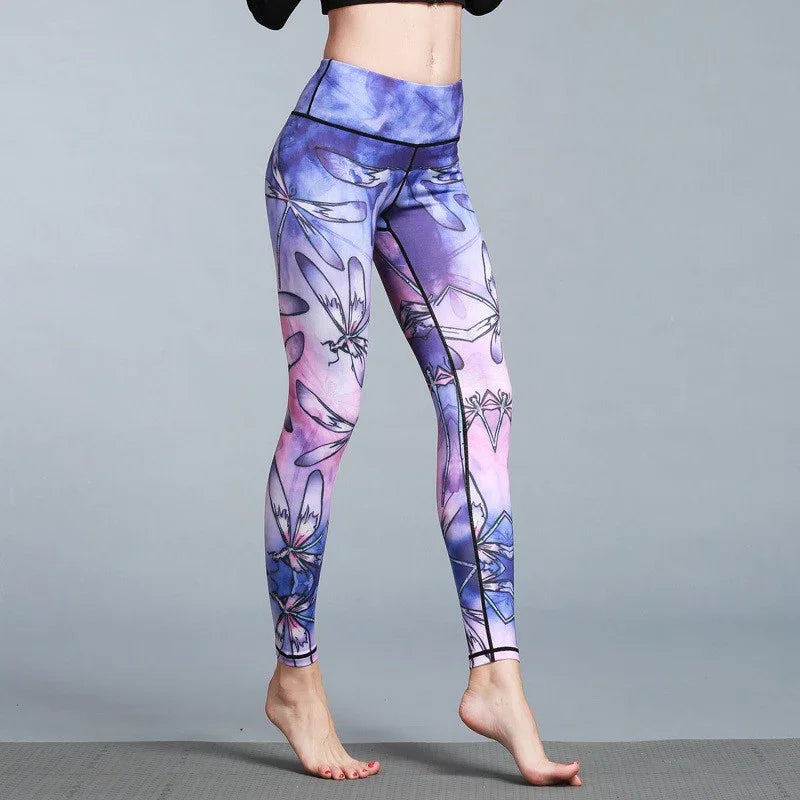 Woman wearing high-waisted purple and pink floral print leggings, slim fit, stretch fabric