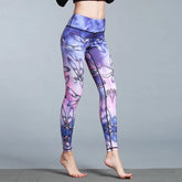 Woman wearing high-waisted purple and pink floral print leggings, slim fit, stretch fabric