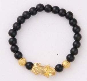 Black beaded bracelet with gold accents and a gold charm, modern streetwear accessory