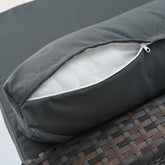 Close-up of a dark gray zippered cushion cover on a wicker outdoor furniture piece