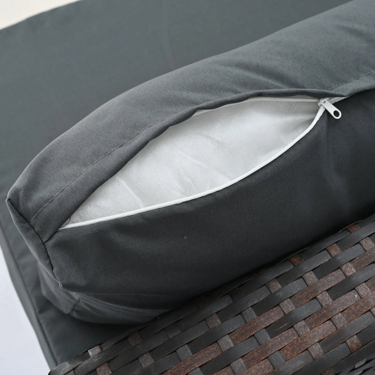 Close-up of a dark gray zippered cushion cover on a wicker outdoor furniture piece