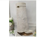 Beige suede knee-high boot with pointed toe, wide shaft, gold buckle, modern streetwear style