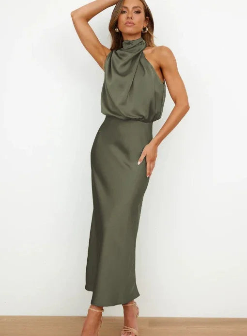 Woman wearing an olive green satin halter neck maxi dress with a relaxed fit