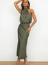 Woman wearing an olive green satin halter neck maxi dress with a relaxed fit