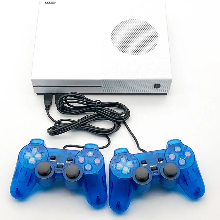 White gaming console with two wired blue transparent controllers on a white surface