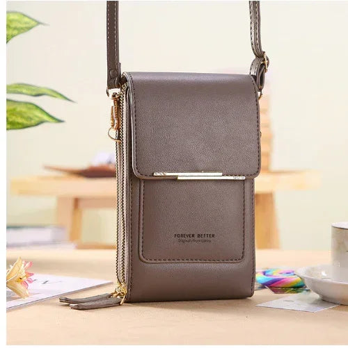Brown faux leather crossbody phone bag with slim fit, flap closure, and gold hardware detail.