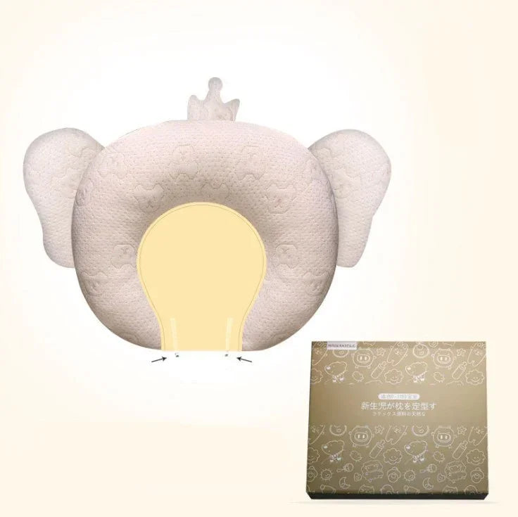 Beige animal-shaped baby pillow with ear design, soft fabric, ergonomic fit, and gift box.