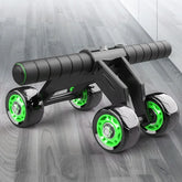 Black and neon green ab roller with four wheels and padded handles on a wood floor