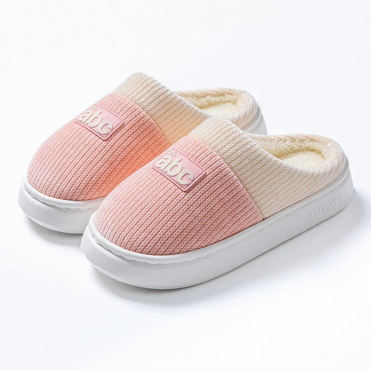 Cozy pink and cream ribbed slip-on slippers with plush lining and chunky white soles
