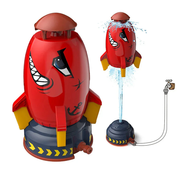 Red plastic rocket-shaped water sprinkler toy with yellow fins and fun face design.