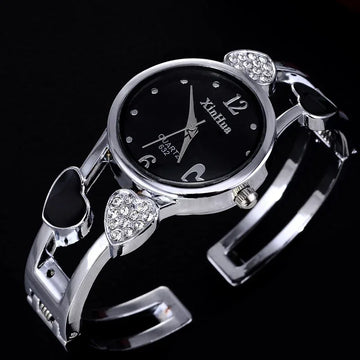 Silver women's watch with black dial, heart accents, and crystal embellishments