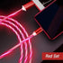 Red LED charging cables with metallic connectors plugged into a smartphone and laptop