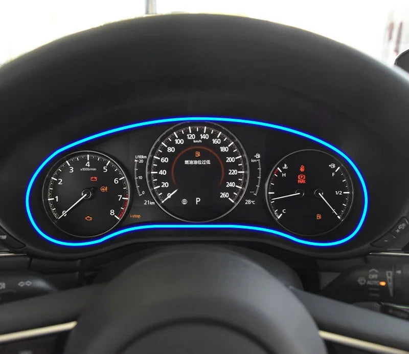Modern digital car dashboard with blue LED trim, illuminated speedometer and gauges