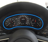 Modern digital car dashboard with blue LED trim, illuminated speedometer and gauges