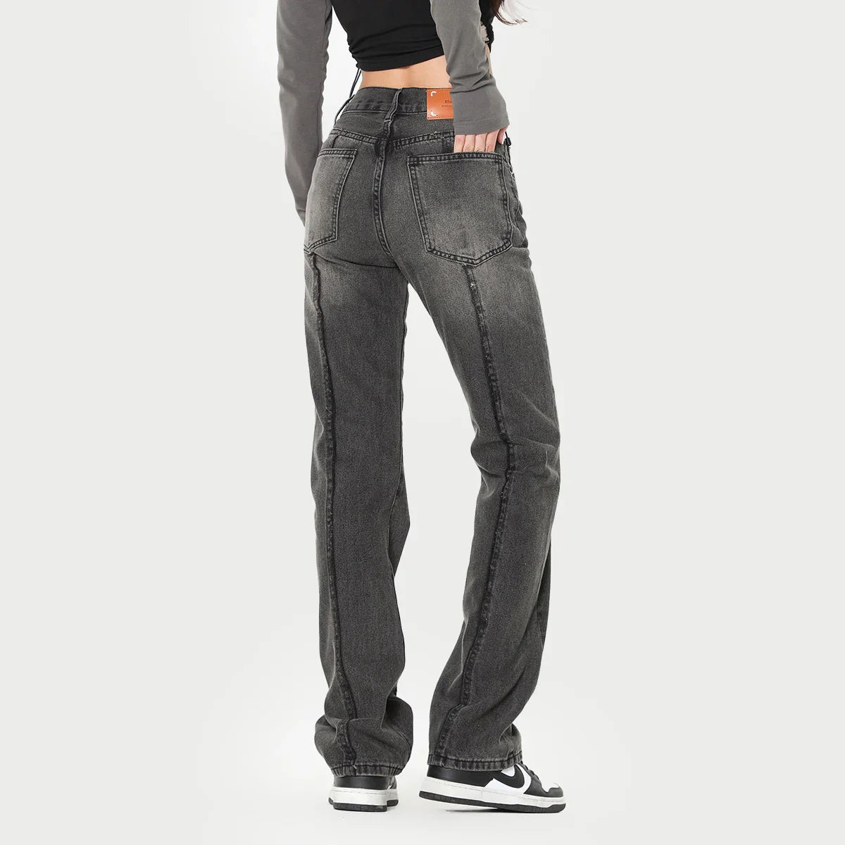 Woman wearing high-waisted straight leg black washed denim jeans, relaxed fit