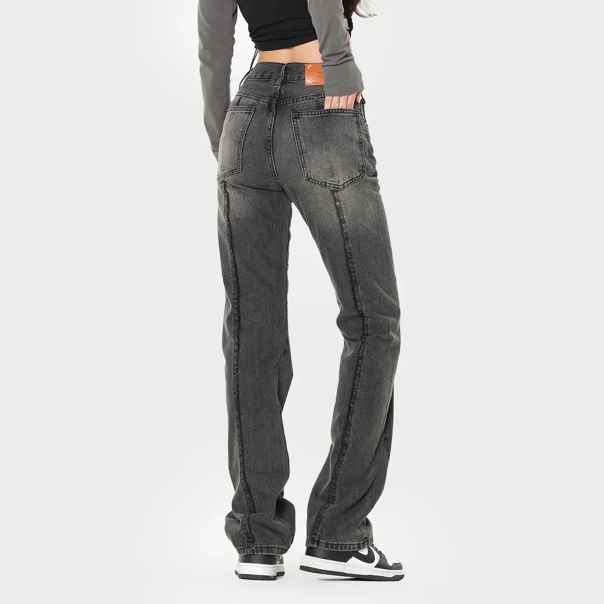 Woman wearing high-waisted straight leg black washed denim jeans, relaxed fit