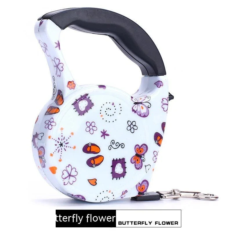 White retractable dog leash with colorful butterfly and flower pattern, ergonomic black handle