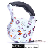 White retractable dog leash with colorful butterfly and flower pattern, ergonomic black handle
