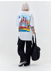 Oversized grey graphic t-shirt with bottle print, black cargo pants, relaxed streetwear style