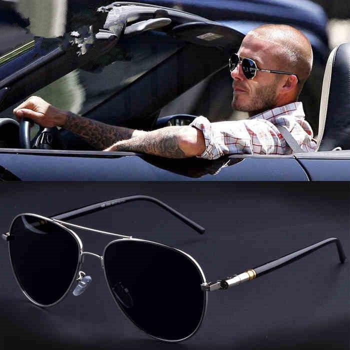 Man in casual plaid shirt driving convertible, wearing black aviator sunglasses; close-up of black metal aviator sunglasses below.