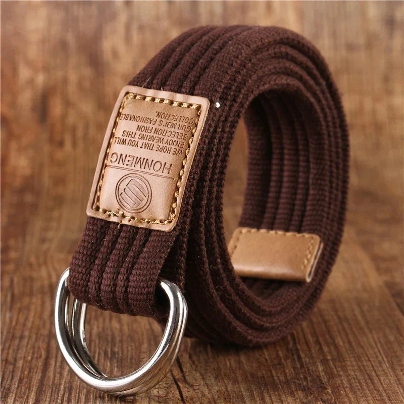 Brown canvas belt with double D-ring buckle and leather accents on wooden surface